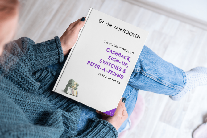 person holding the ultimate cashback guide ebook